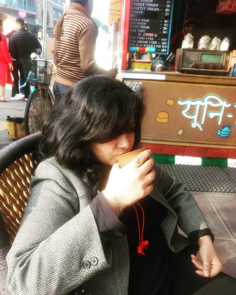 girl drinking tea in earthen pot